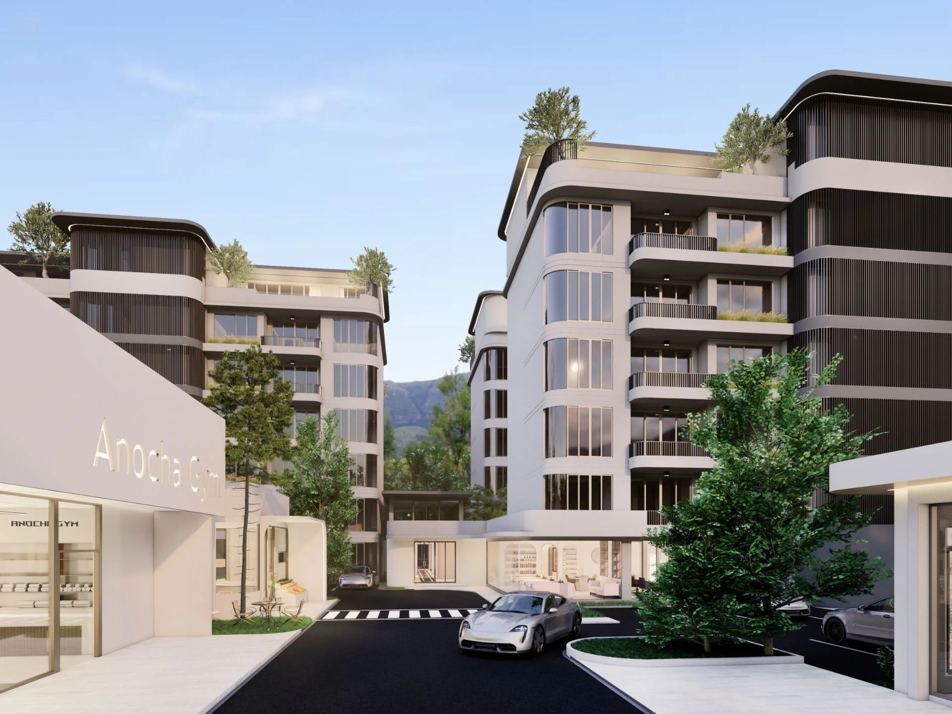 Architecture du complexe résidentiel The Element Kamala avec façades courbes modernes et vues sur les montagnes